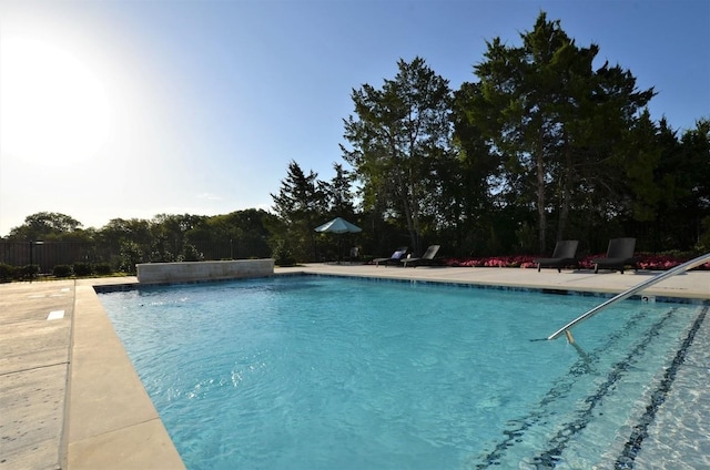 view of swimming pool with pool water feature