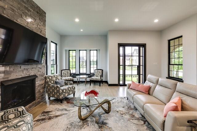 living room featuring hardwood / wood-style floors and a stone fireplace