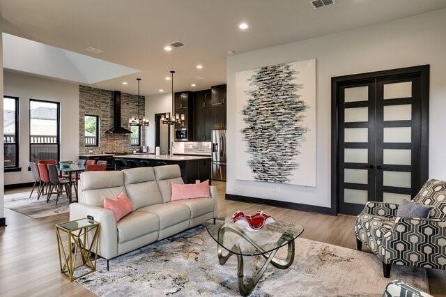 living room featuring an inviting chandelier and light hardwood / wood-style floors