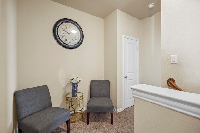 sitting room featuring light carpet