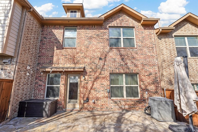 rear view of house featuring a patio area and central air condition unit