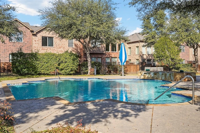 view of swimming pool with a patio