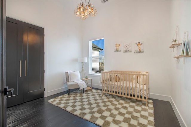 sitting room featuring an inviting chandelier and dark hardwood / wood-style floors