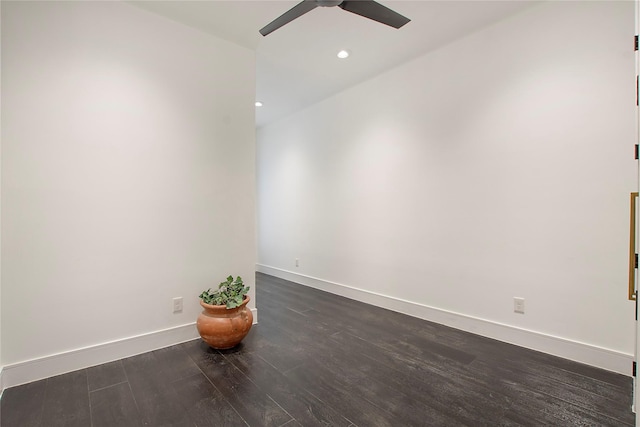 empty room with ceiling fan and dark wood-type flooring