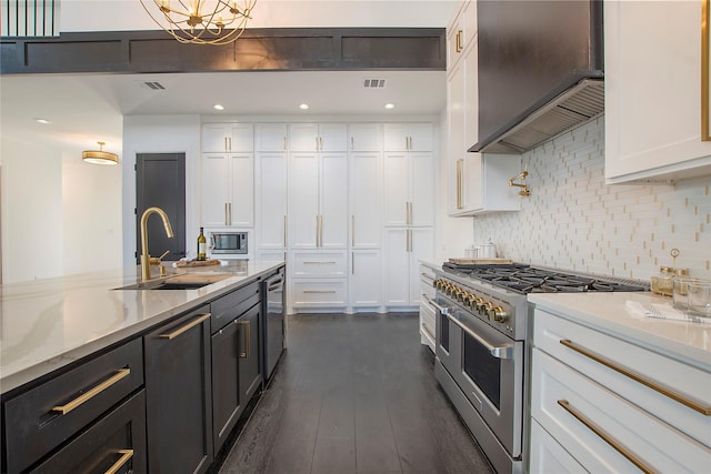 kitchen featuring stainless steel appliances, white cabinets, and custom exhaust hood