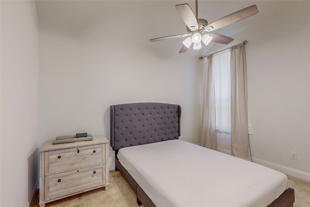 bedroom with ceiling fan and light carpet