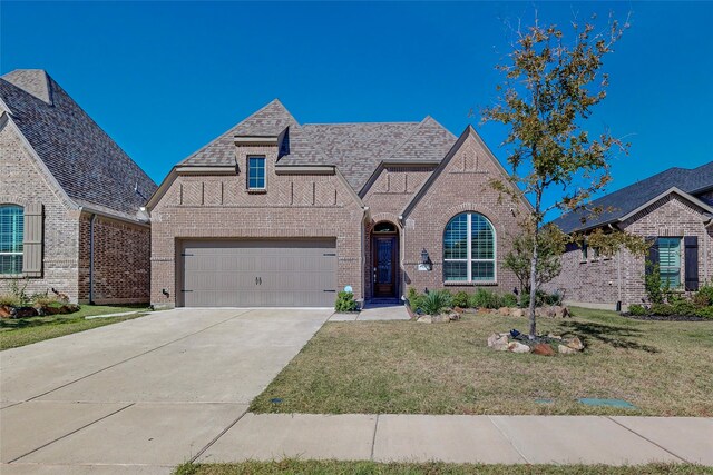 view of front of house with a front yard and a garage