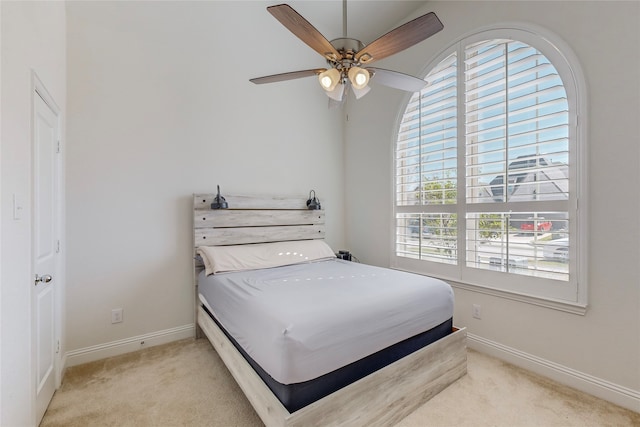 bedroom featuring ceiling fan and light carpet