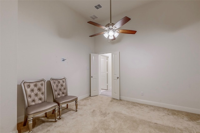 sitting room featuring high vaulted ceiling, ceiling fan, and light colored carpet