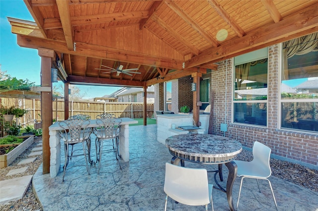 view of patio / terrace featuring an outdoor bar and ceiling fan