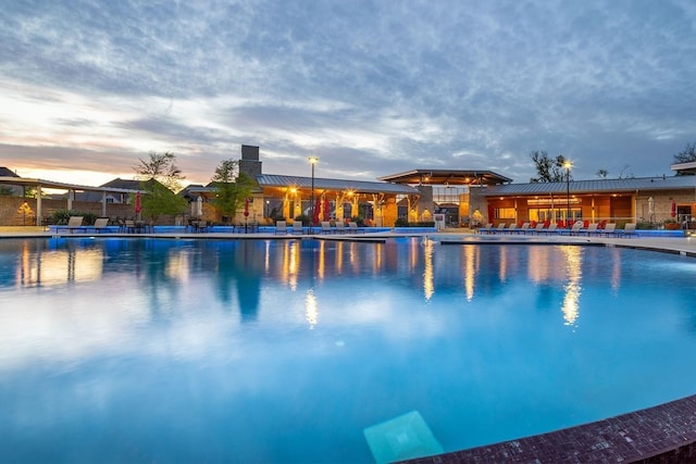 view of pool at dusk