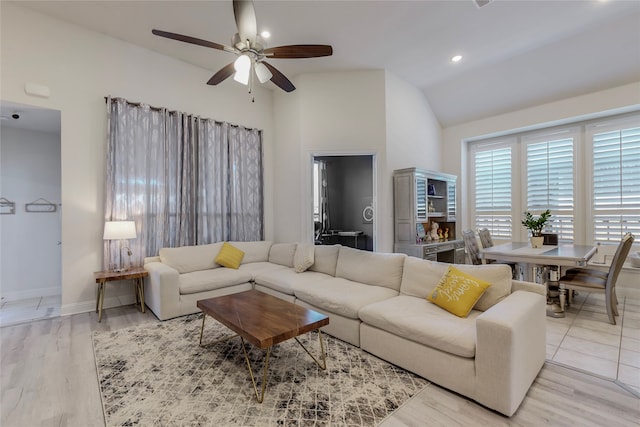 living room featuring lofted ceiling, ceiling fan, and light hardwood / wood-style floors