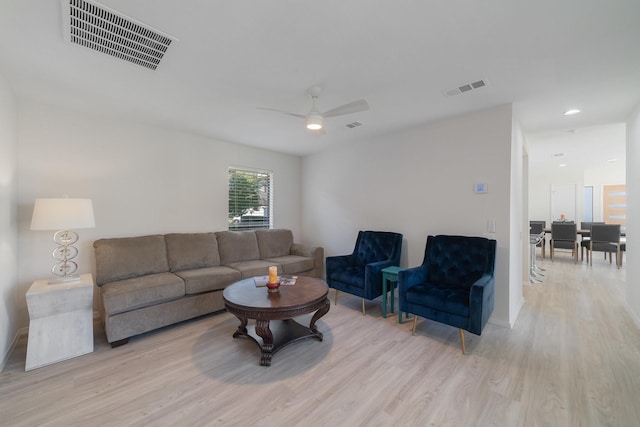 living room with light wood-type flooring and ceiling fan