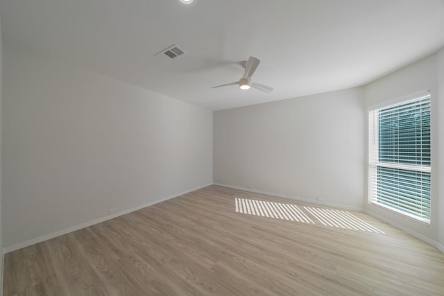 spare room featuring ceiling fan and light hardwood / wood-style floors