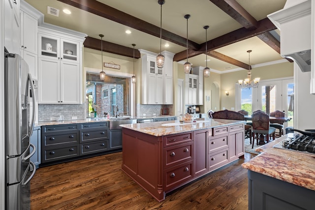 kitchen featuring appliances with stainless steel finishes, white cabinetry, and a center island