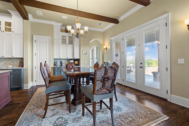 dining area with ornamental molding, french doors, dark hardwood / wood-style floors, beam ceiling, and an inviting chandelier