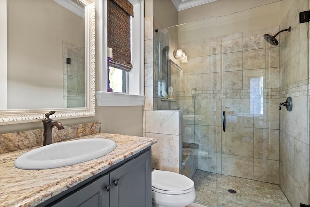 bathroom featuring toilet, a shower with door, crown molding, and vanity