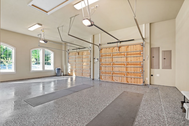 garage with a garage door opener and electric panel