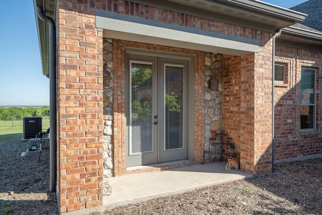 property entrance featuring french doors and cooling unit