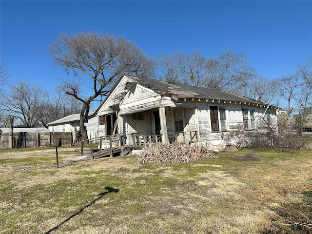 view of side of home with a lawn