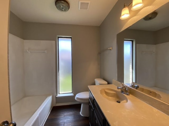 bathroom with hardwood / wood-style flooring, vanity, and toilet