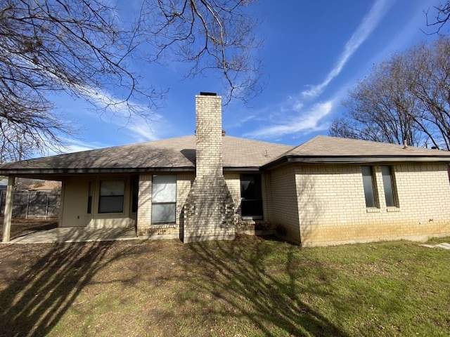 back of house with a lawn