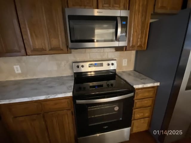 kitchen featuring stainless steel appliances and backsplash