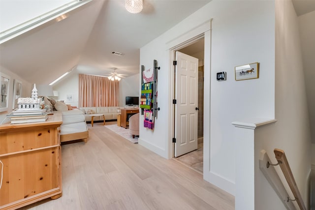 bedroom with light hardwood / wood-style floors, ceiling fan, and vaulted ceiling