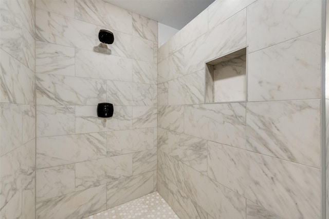 bathroom with tiled shower