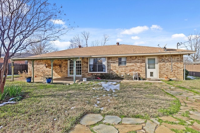 rear view of property with a patio area and a yard