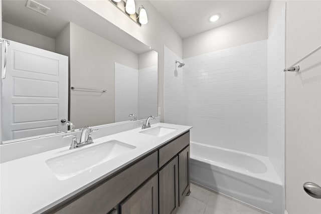 bathroom featuring vanity and tiled shower / bath combo