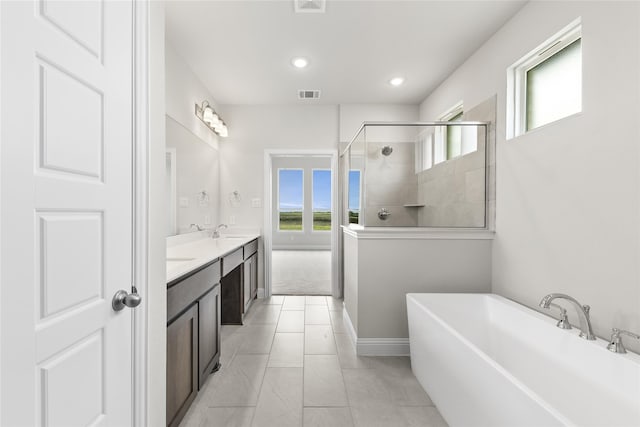 bathroom featuring shower with separate bathtub and vanity