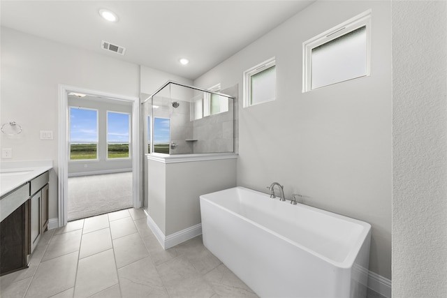 bathroom featuring shower with separate bathtub and vanity