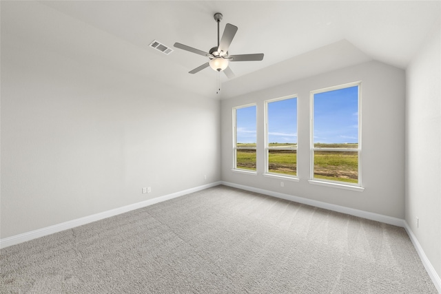 carpeted spare room featuring lofted ceiling and ceiling fan