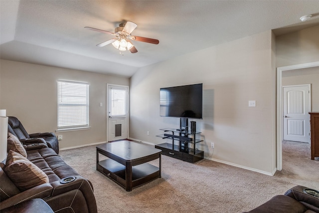 living room with ceiling fan, light carpet, and vaulted ceiling