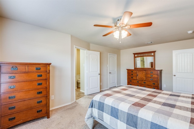 bedroom with ceiling fan, connected bathroom, and light carpet