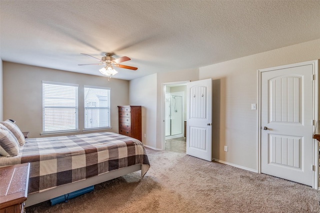 bedroom featuring ceiling fan, carpet, and a textured ceiling