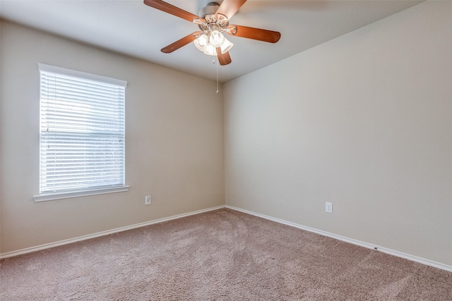 spare room featuring carpet, ceiling fan, and plenty of natural light