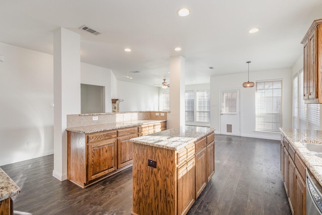 kitchen featuring hanging light fixtures, dark wood-type flooring, dishwasher, and a kitchen island