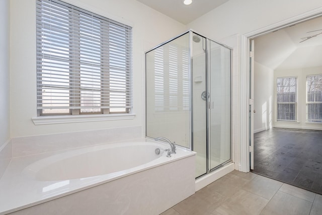 bathroom with independent shower and bath, plenty of natural light, and tile patterned flooring