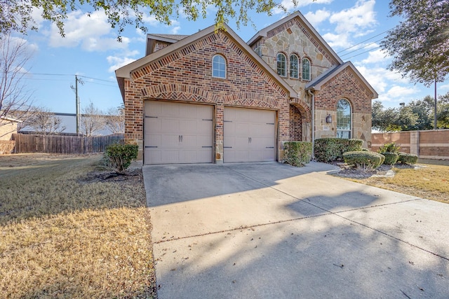 view of property with a garage and a front yard