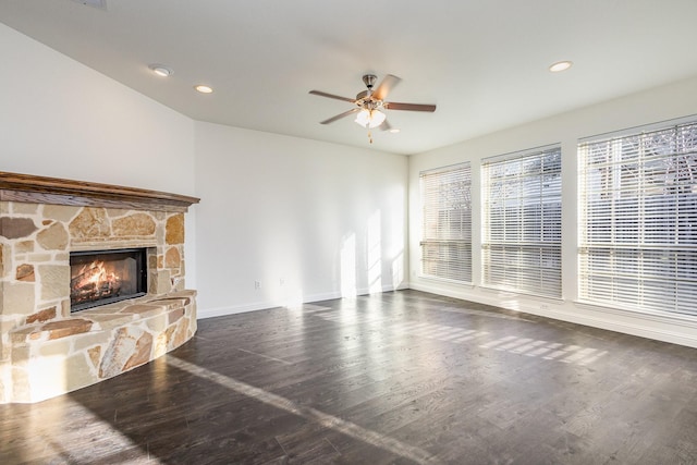 unfurnished living room featuring dark wood-type flooring, a fireplace, and ceiling fan