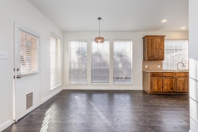 unfurnished dining area with dark wood-type flooring and sink