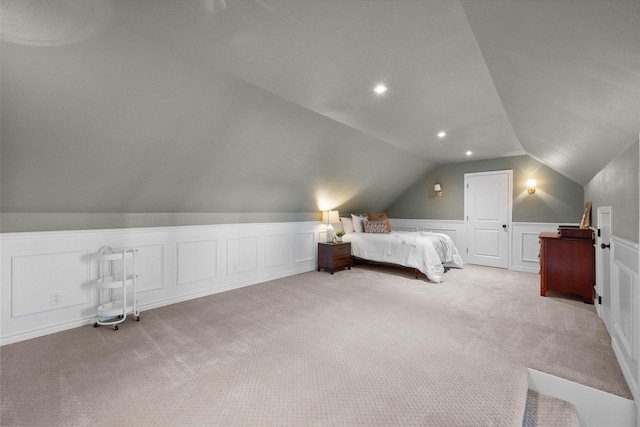 unfurnished bedroom featuring light carpet and vaulted ceiling