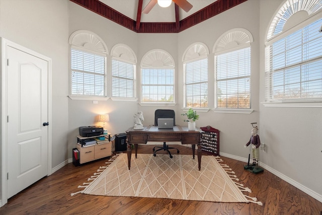 office space with ceiling fan, vaulted ceiling, and dark wood-type flooring