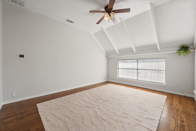 unfurnished room with ceiling fan, lofted ceiling with beams, and dark hardwood / wood-style floors