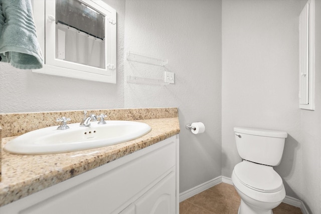 bathroom featuring tile patterned floors, toilet, and vanity