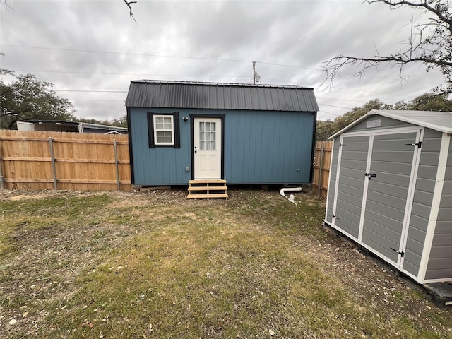 view of outbuilding featuring a yard