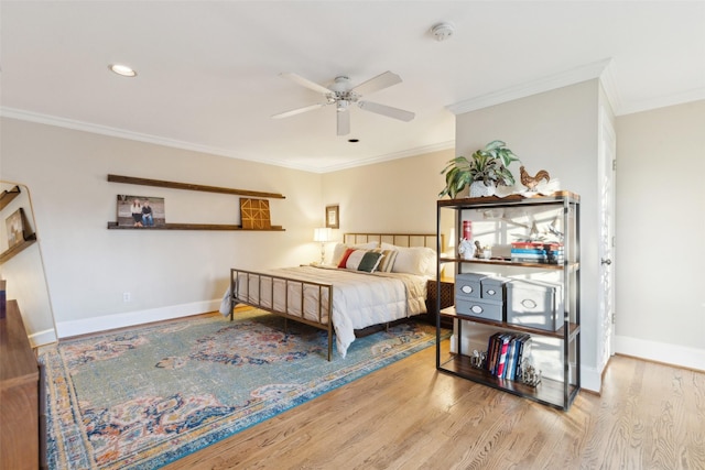 bedroom featuring ceiling fan, crown molding, and hardwood / wood-style floors