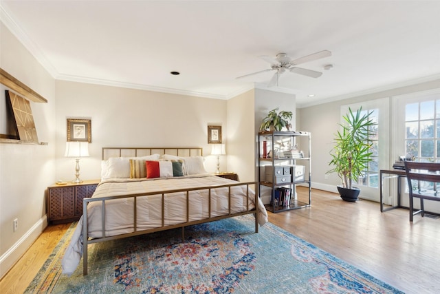 bedroom with ceiling fan, ornamental molding, and hardwood / wood-style floors